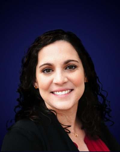 Professional woman smiling portrait with dark blue background, showcasing confidence and friendlines.