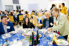 Business professionals enjoying a formal dinner at a conference event.